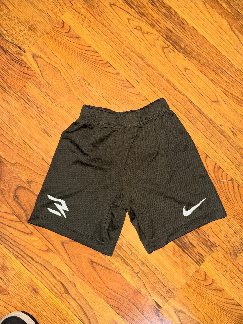 Nike Kids Black Athletic Shorts with White Swoosh